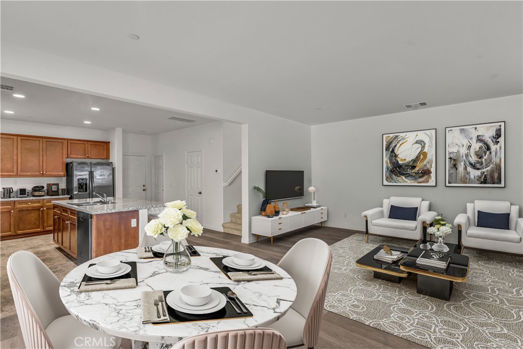 687 South Fillmore Avenue Rialto, CA 92376 - Photo 8 of 39 a living room with furniture kitchen view and a flat screen tv