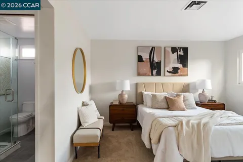 a bedroom with bed and a chair