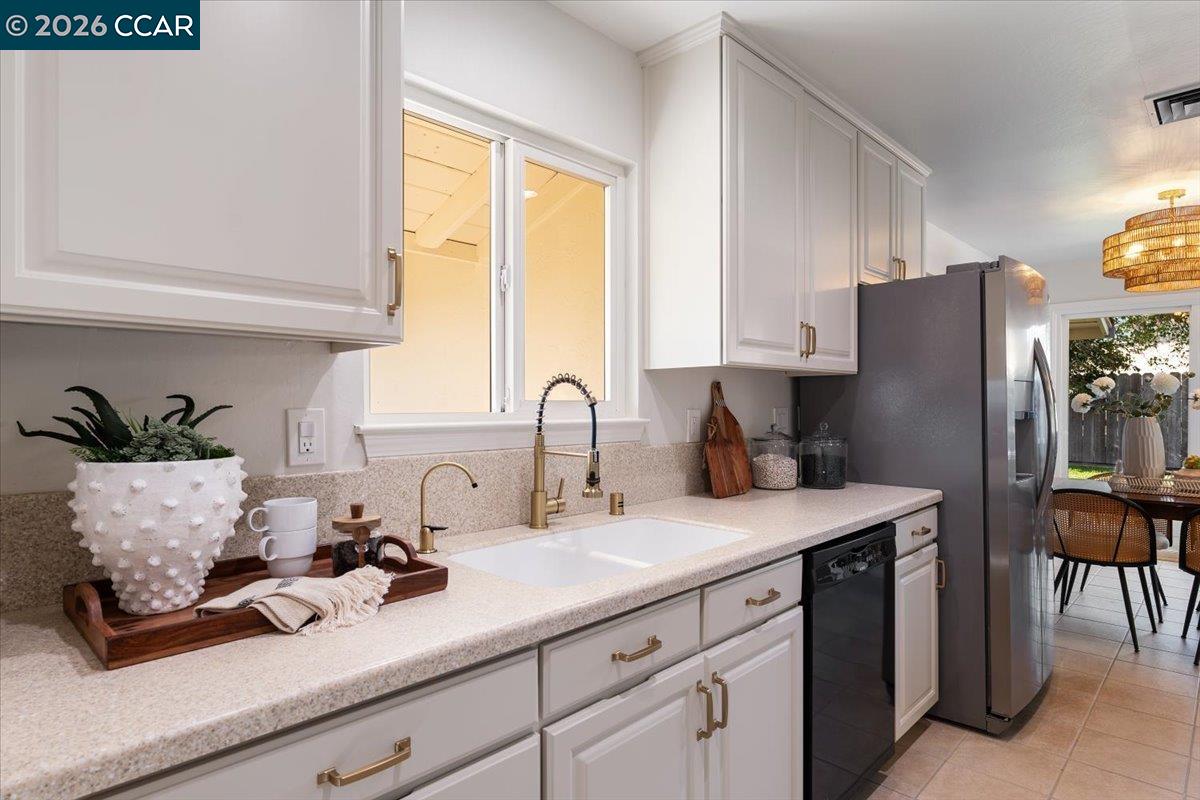 4095 Hamlet Drive Concord, CA 94521 - Photo 7 of 26 a kitchen with stainless steel appliances sink refrigerator table and chairs
