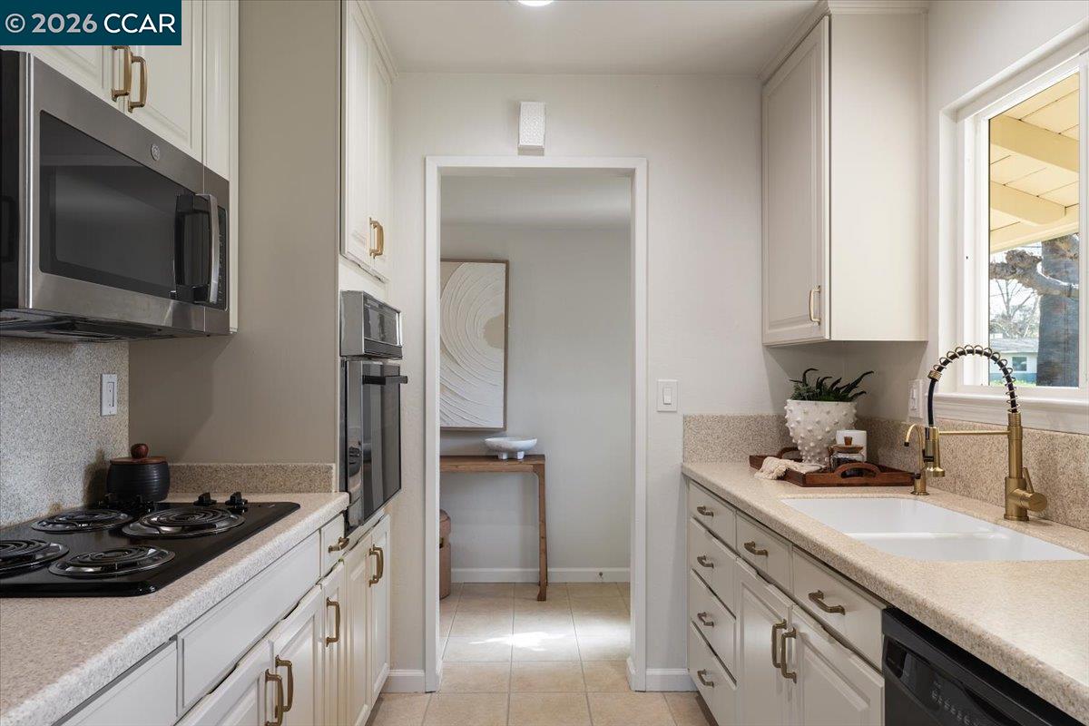 4095 Hamlet Drive Concord, CA 94521 - Photo 8 of 26 a kitchen with stainless steel appliances a stove sink and microwave