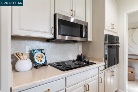 a kitchen with a stove and a microwave