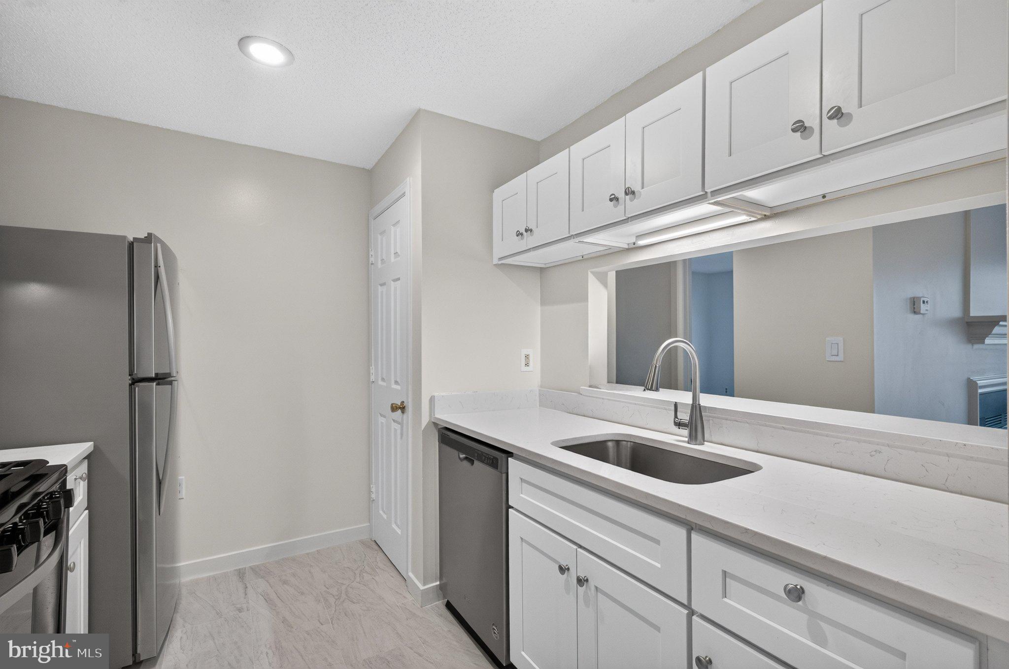 21029 Timber Ridge Terrace, Unit 302 Ashburn, VA 20147 - Photo 12 of 29 Modern kitchen with sleek finishes.
