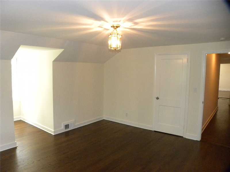 67 Peach Hill Road Darien, CT 06820 - Photo 19 of 25 an empty room with wooden floor and windows