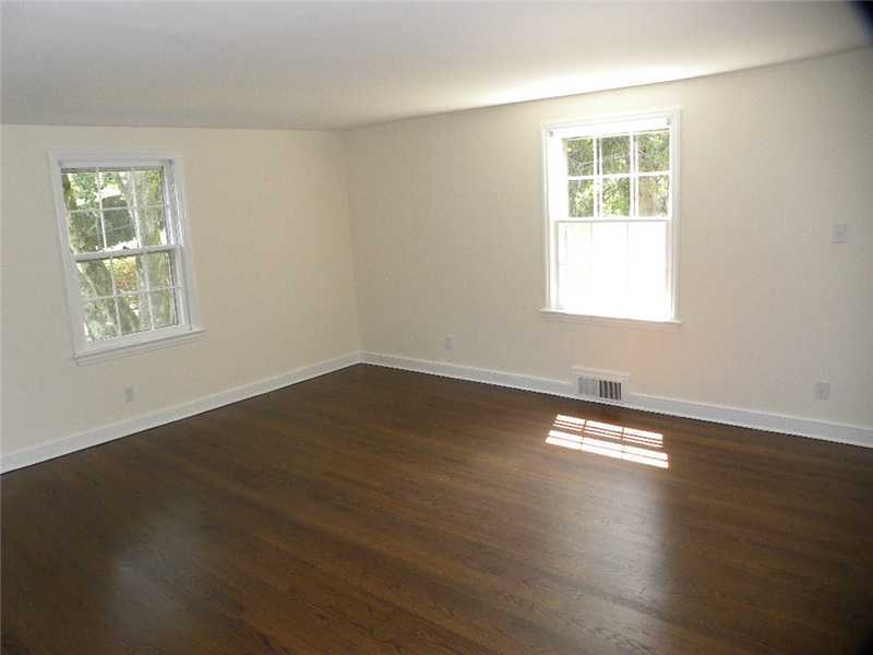 67 Peach Hill Road Darien, CT 06820 - Photo 20 of 25 an empty room with wooden floor and windows