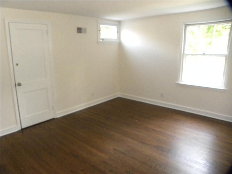 67 Peach Hill Road Darien, CT 06820 - Photo 21 of 25 an empty room with wooden floor and windows