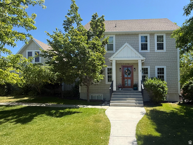 776 Canyon Road Hyde Park, UT 84318 - Photo 2 of 57 Craftsman-style home featuring shake siding, a covered entry porch with white columns, and a rich wood-finish front door