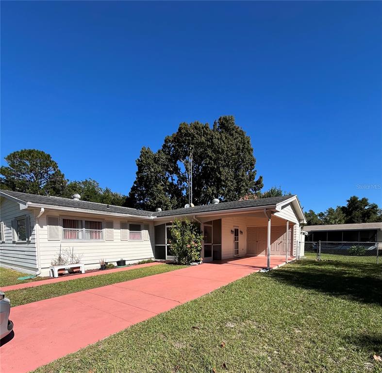 3573 Southwest 147 Lane Road Ocala, FL 34473 - Photo 1 of 1 a front view of a house with a garden and yard