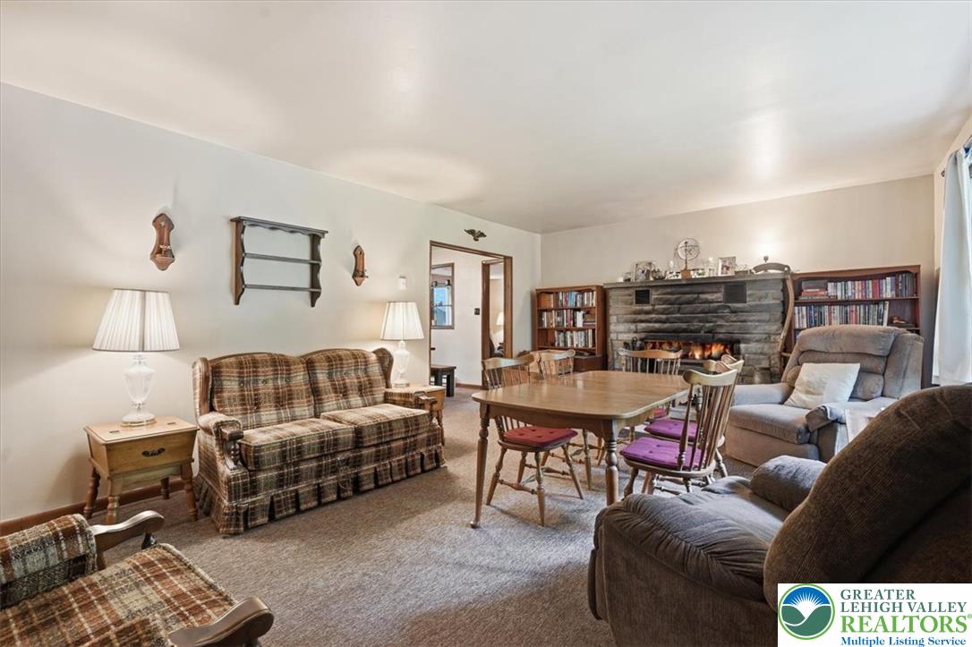 143 Logger Road Canadensis, PA 18325 - Photo 3 of 32 A cozy living space invites with a stone fireplace, perfect for gathering.
