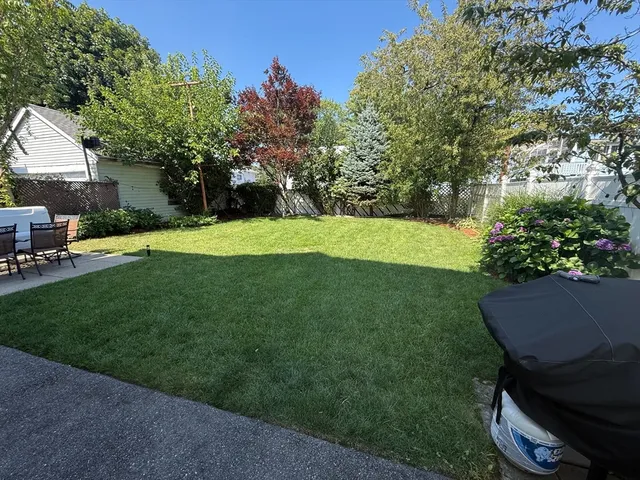 a view of a backyard with sitting area