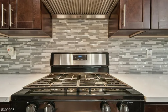 a stove top oven sitting inside of a kitchen