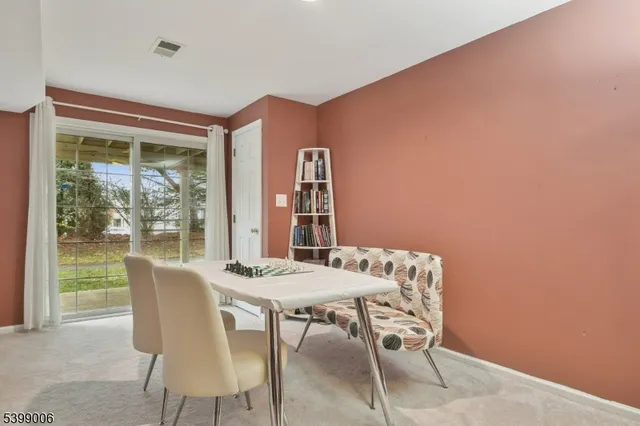 a dining room with furniture and window