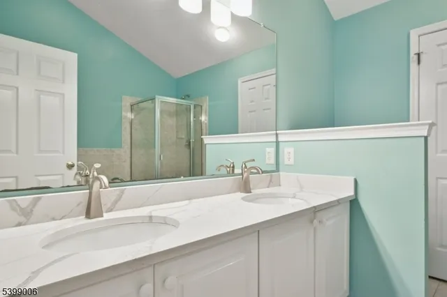 a bathroom with a double vanity sink and a mirror