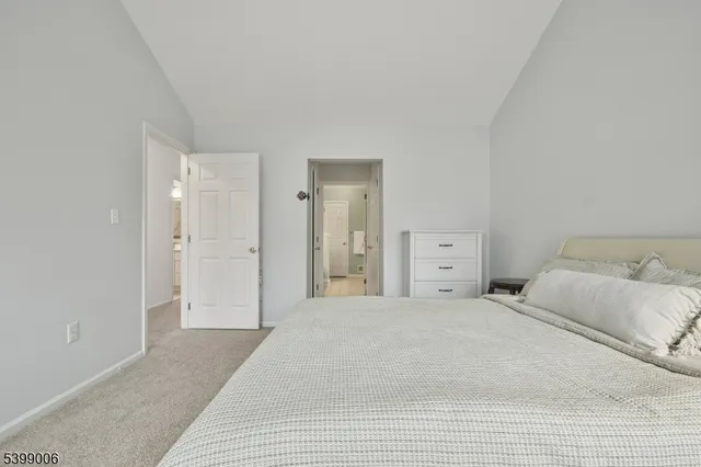 a large white bed in a white room