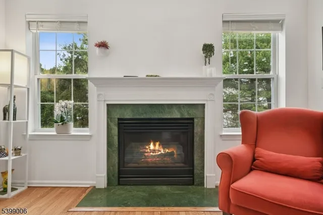 a living room with furniture a window and a fireplace