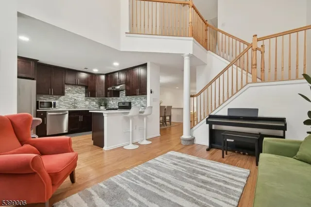 a living room with furniture and a kitchen view