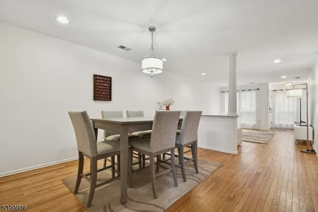 a view of a dining room with furniture wooden floor and chandelier