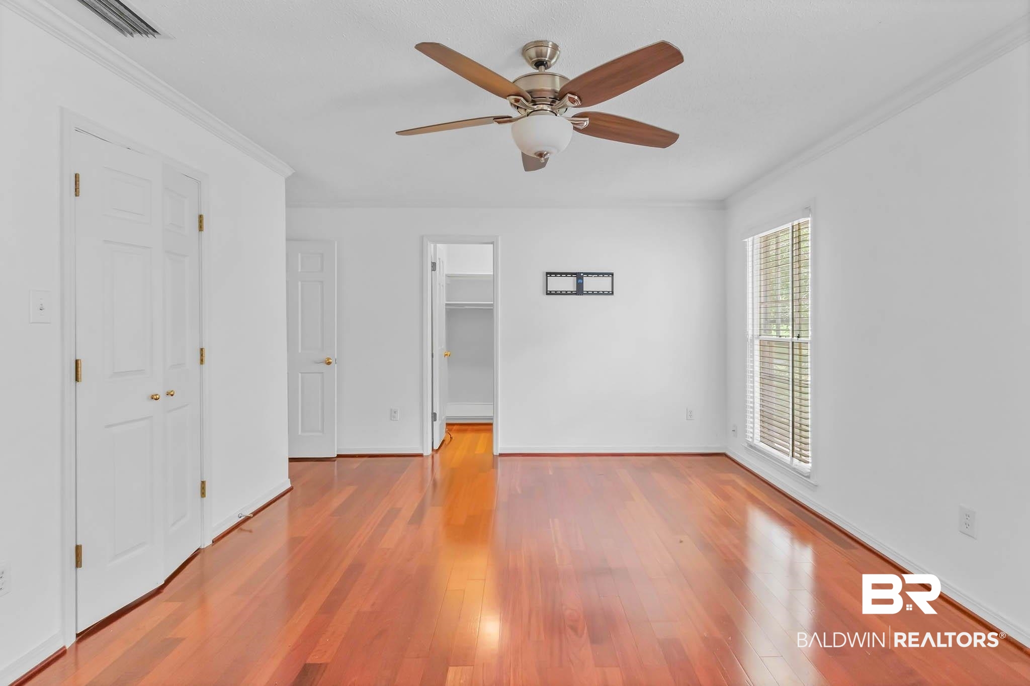 309 West Brandy Run Road Mobile, AL 36608 - Photo 39 of 100 Unfurnished bedroom with wood finished floors, ornamental molding, a walk in closet, and ceiling fan