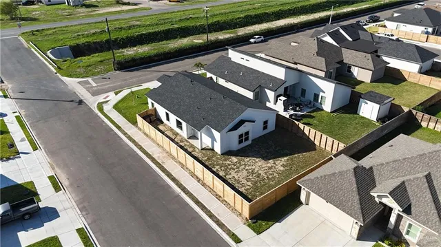 an aerial view of residential houses with outdoor space