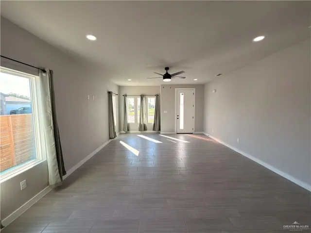 an empty room with windows and entrance