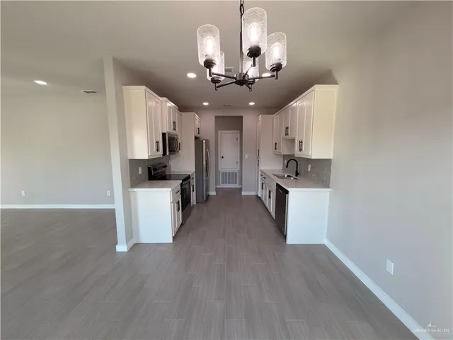 a view of kitchen with sink microwave and refrigerator