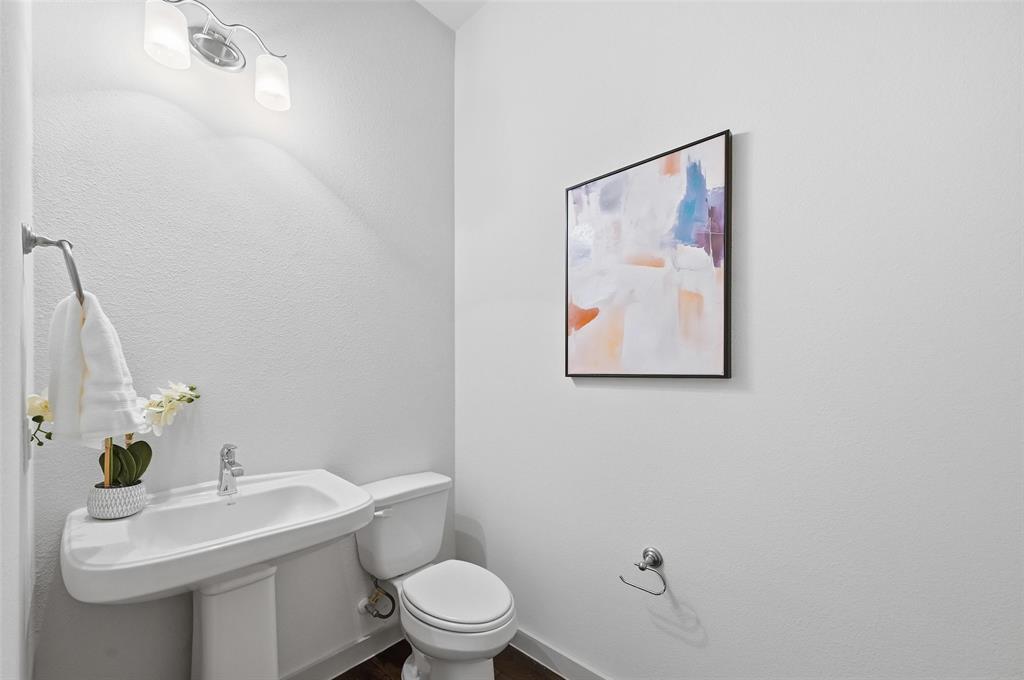 4836 Paddock Trail Carrollton, TX 75010 - Photo 14 of 25 a bathroom with a toilet a sink and mirror