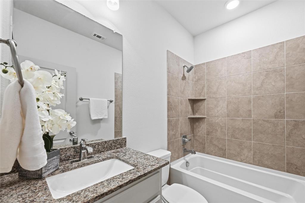 4836 Paddock Trail Carrollton, TX 75010 - Photo 16 of 25 a bathroom with a granite countertop sink and a mirror
