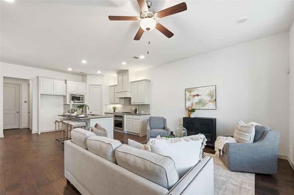 4836 Paddock Trail Carrollton, TX 75010 - Photo 4 of 25 a living room with furniture kitchen view and a chandelier