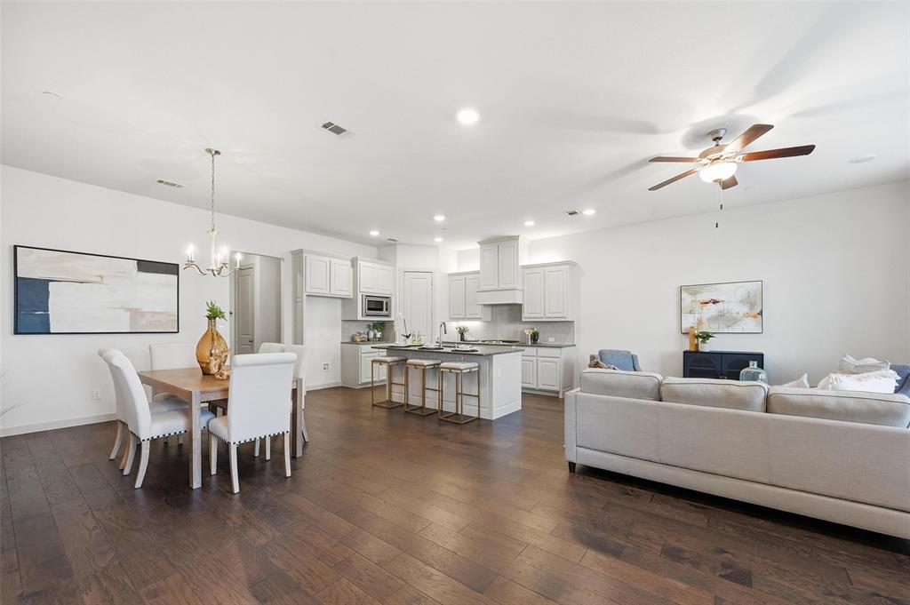 4836 Paddock Trail Carrollton, TX 75010 - Photo 6 of 25 a living room with furniture kitchen view and a chandelier