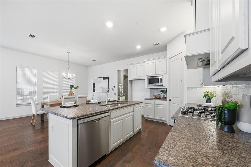 4836 Paddock Trail Carrollton, TX 75010 - Photo 10 of 25 a kitchen with a sink stove and cabinets