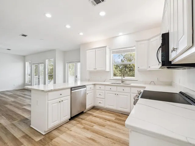 a kitchen with a sink stove and cabinets