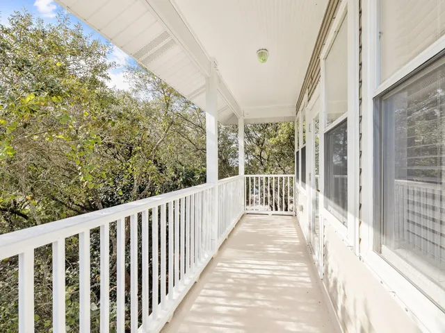 a view of a balcony with wooden floor