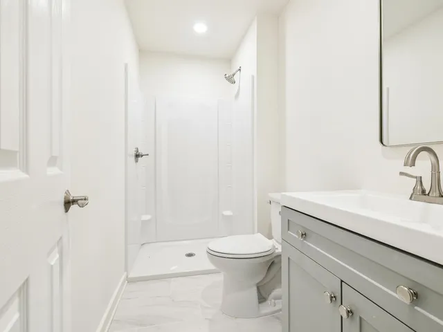 a bathroom with a sink a toilet and a mirror