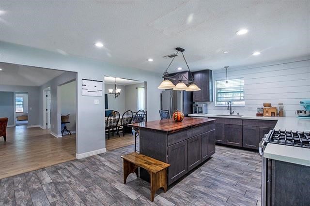 545 Elm Street Sour Lake, TX 77659 - Photo 12 of 15 a kitchen with stainless steel appliances granite countertop a sink stove and wooden floor