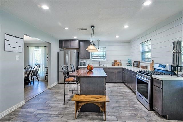 545 Elm Street Sour Lake, TX 77659 - Photo 14 of 15 a kitchen view with stainless steel appliances kitchen island granite countertop a table chairs sink and cabinets