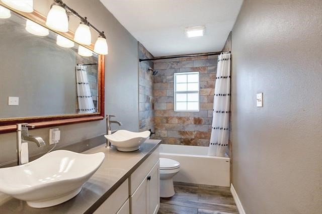 545 Elm Street Sour Lake, TX 77659 - Photo 2 of 15 a bathroom with a granite countertop sink and mirror with bathtub