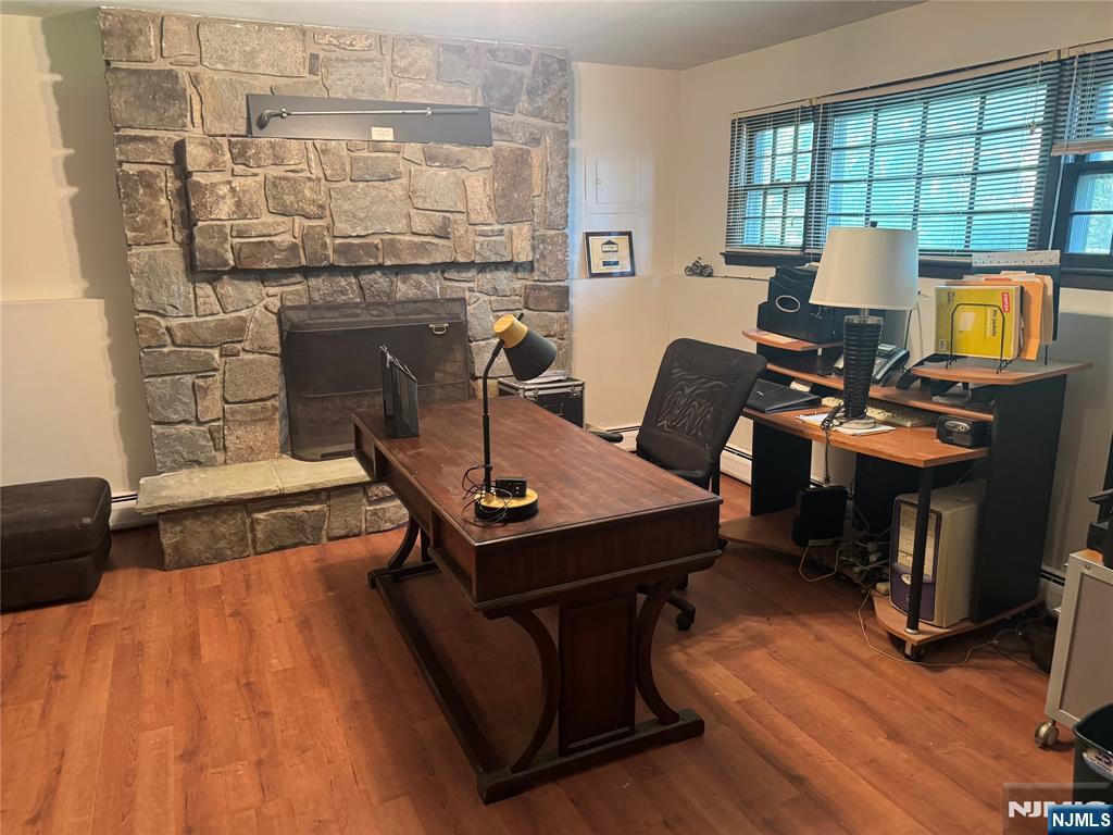 55 Maryann Road Oak Ridge, NJ 07438 - Photo 17 of 20 a living room with furniture and a fireplace