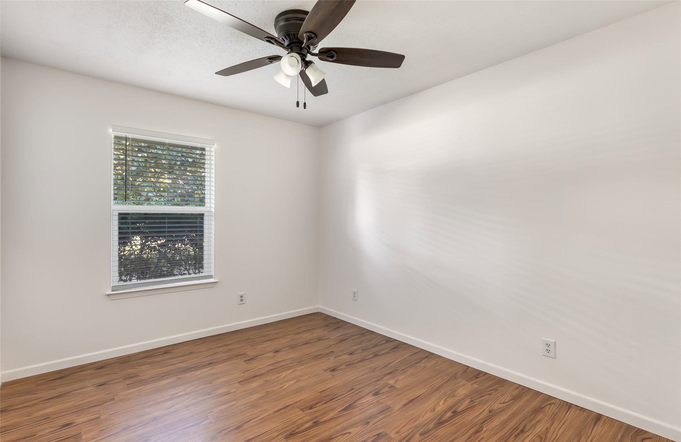 4019 Hillcrest Street Liberty, TX 77575 - Photo 10 of 31 an empty room with a window and a ceiling fan