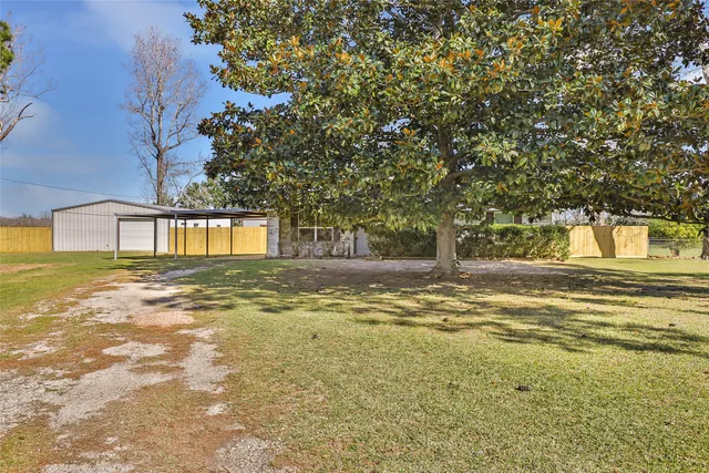 a view of a house with a backyard