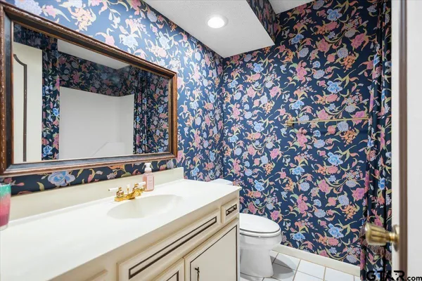 a bathroom with a sink toilet and mirror
