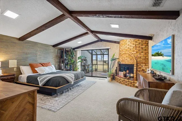 a kitchen with kitchen island granite countertop a refrigerator a stove a sink dishwasher a dining table and chairs with wooden floor