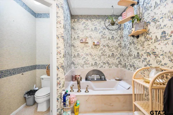 a dining room with wooden floor table and chairs