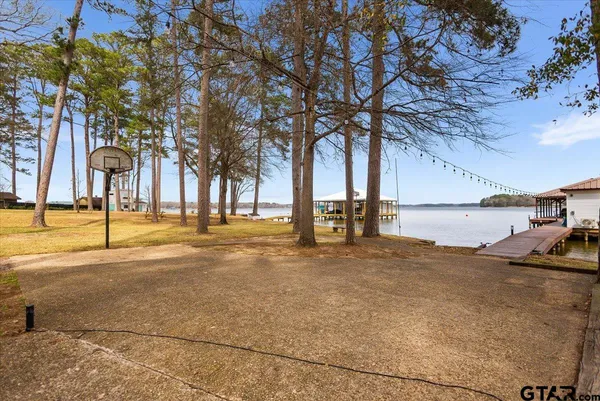 a living room with furniture a ceiling fan and a rug