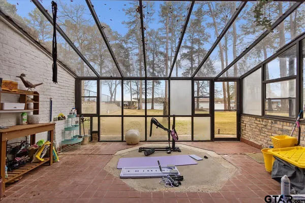 a reading room with furniture and a floor to ceiling window