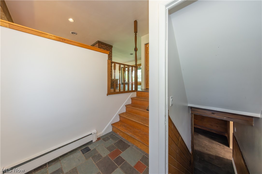 7969 Dines Road Novelty, OH 44072 - Photo 3 of 48 Entryway featuring multi-toned slate tile flooring and a partial wall with wood capping