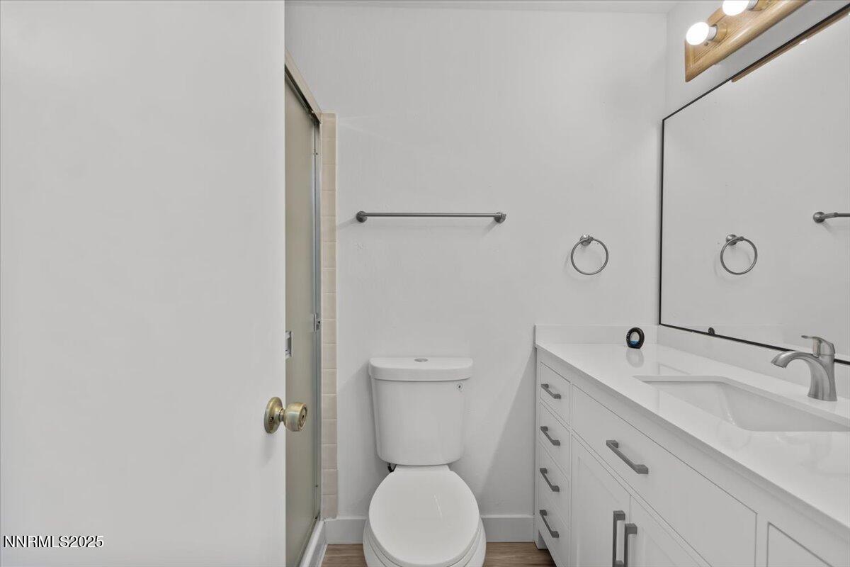 4830 Rampion Way Sun Valley, NV 89433 - Photo 11 of 30 a bathroom with a toilet sink and mirror