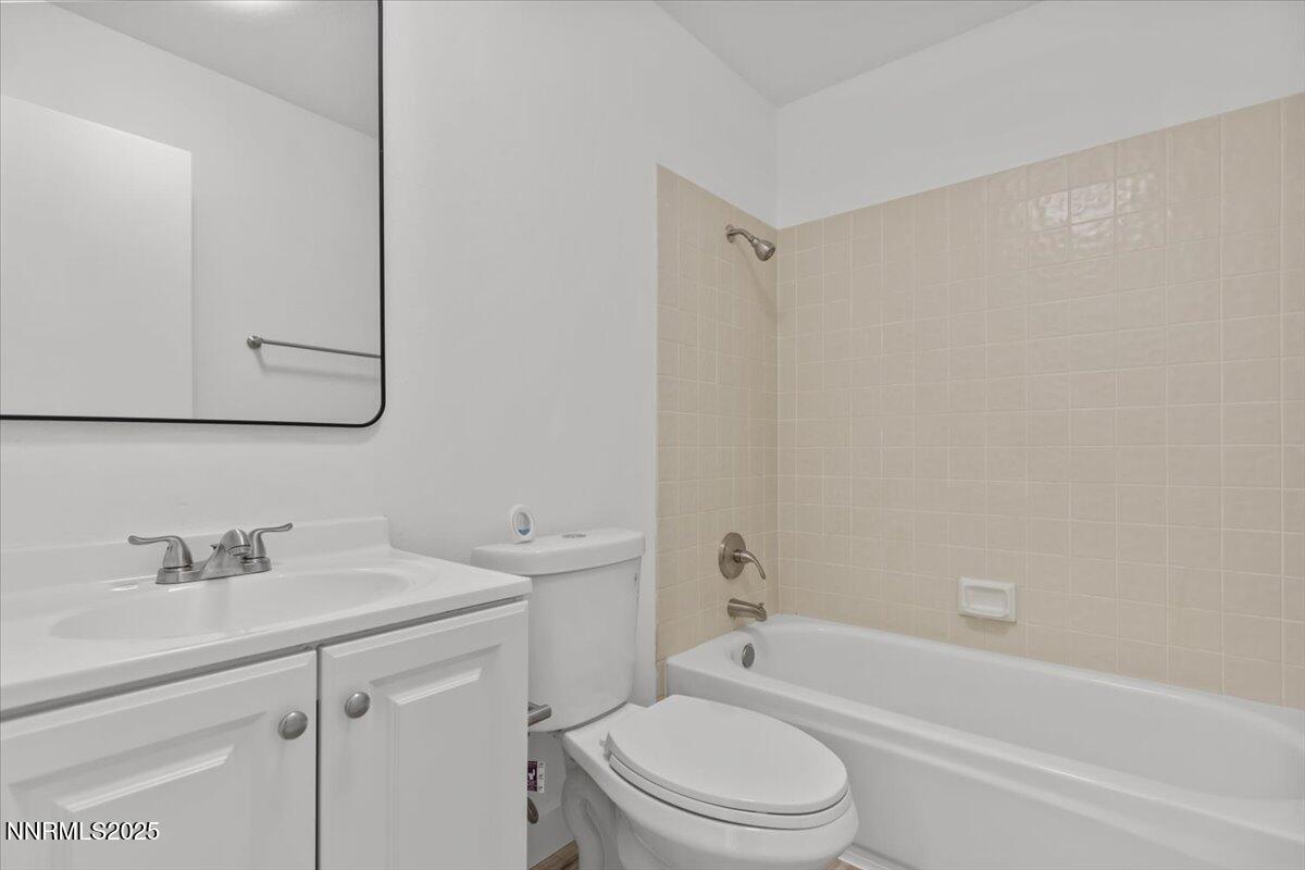 4830 Rampion Way Sun Valley, NV 89433 - Photo 16 of 30 a bathroom with a sink a toilet and shower
