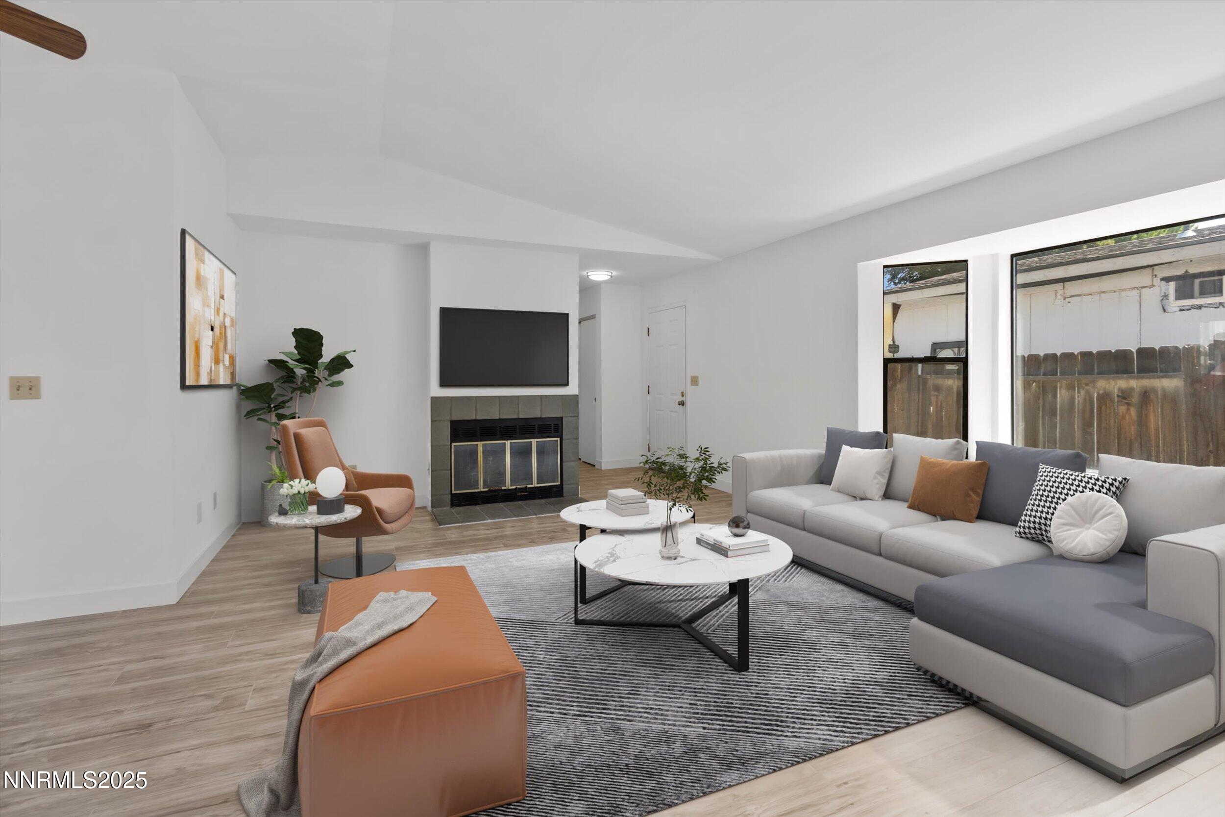 4830 Rampion Way Sun Valley, NV 89433 - Photo 2 of 30 a living room with furniture fireplace and a flat screen tv