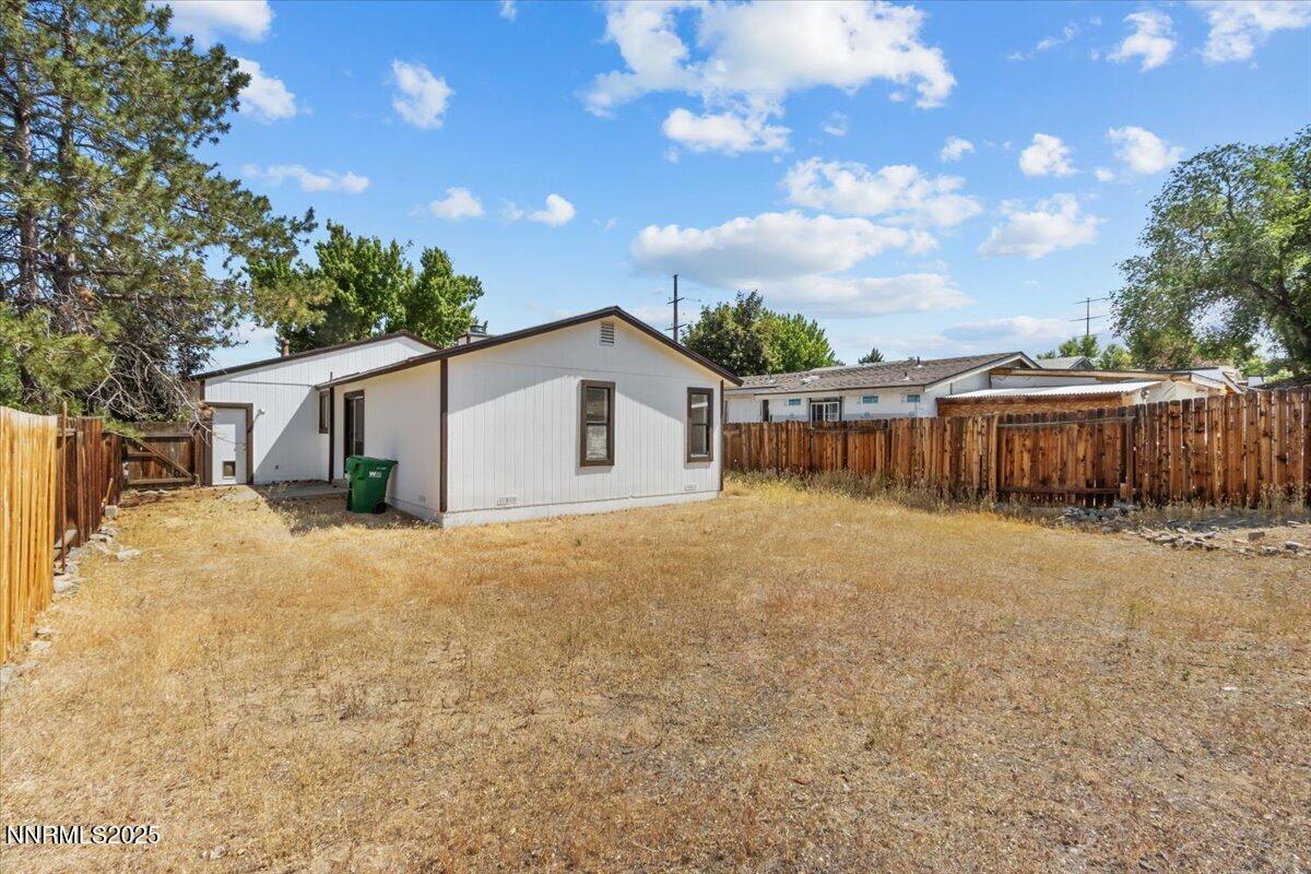 4830 Rampion Way Sun Valley, NV 89433 - Photo 23 of 30 a view of a house with backyard and a tree