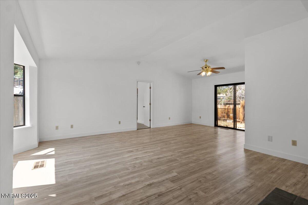4830 Rampion Way Sun Valley, NV 89433 - Photo 5 of 30 an empty room with wooden floor and windows