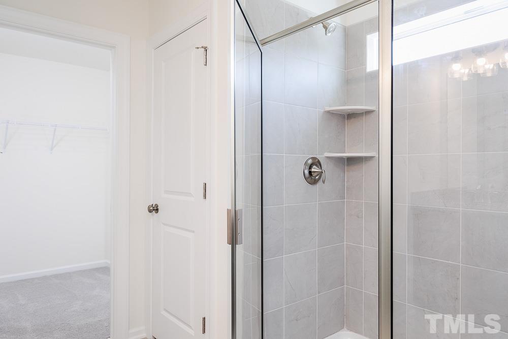 6940 Leesville Road, Unit 10 Raleigh, NC 27613 - Photo 29 of 38 a bathroom with a glass shower door